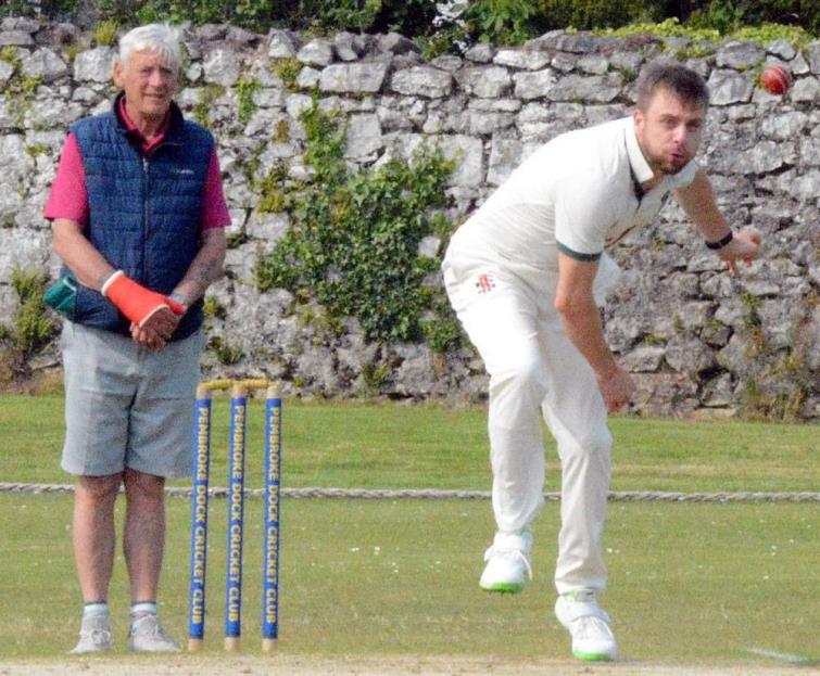 Callum bowling at Imble Lane as umpire Steve  looks on